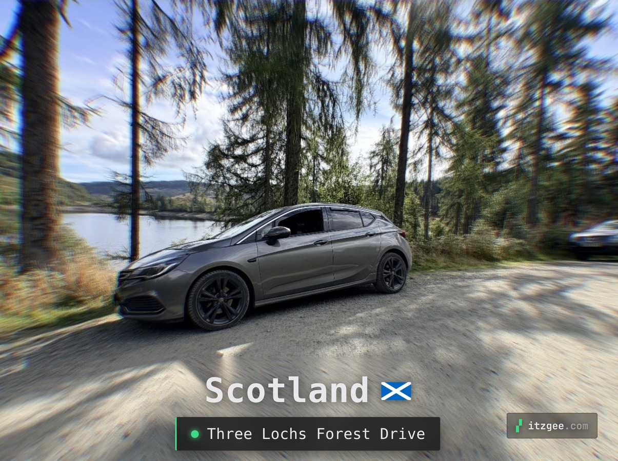 The Cosmic Gray Astra parked beside a loch on the Three Lochs Forest Drive, Scotland